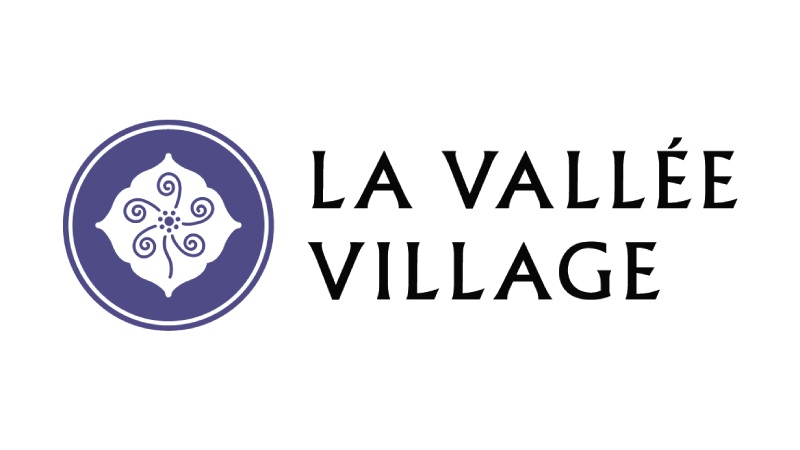 A logo of La Vallee Village, France